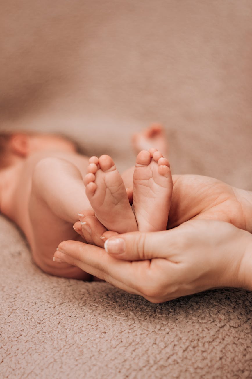 person holding baby feet