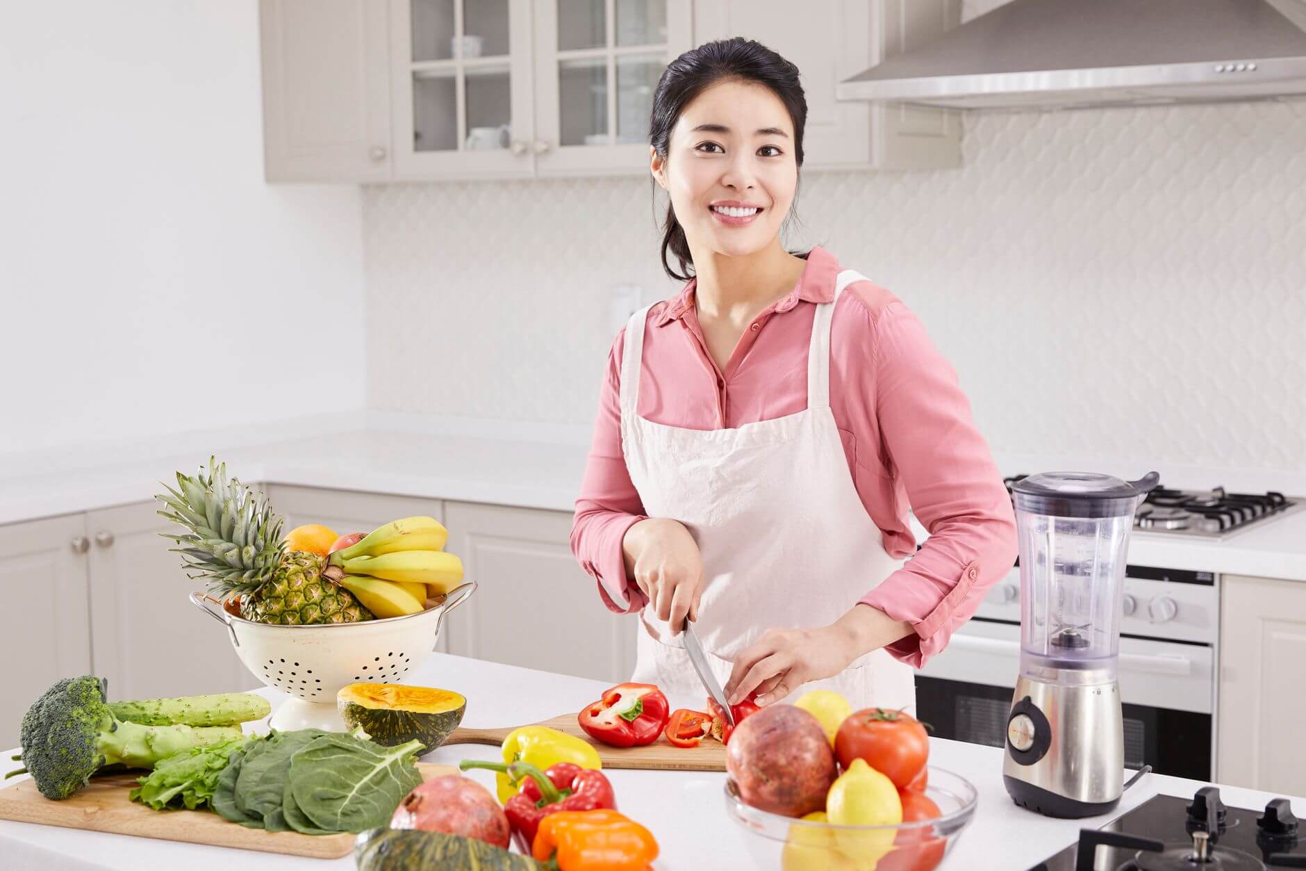 a woman slicing a bell pepper