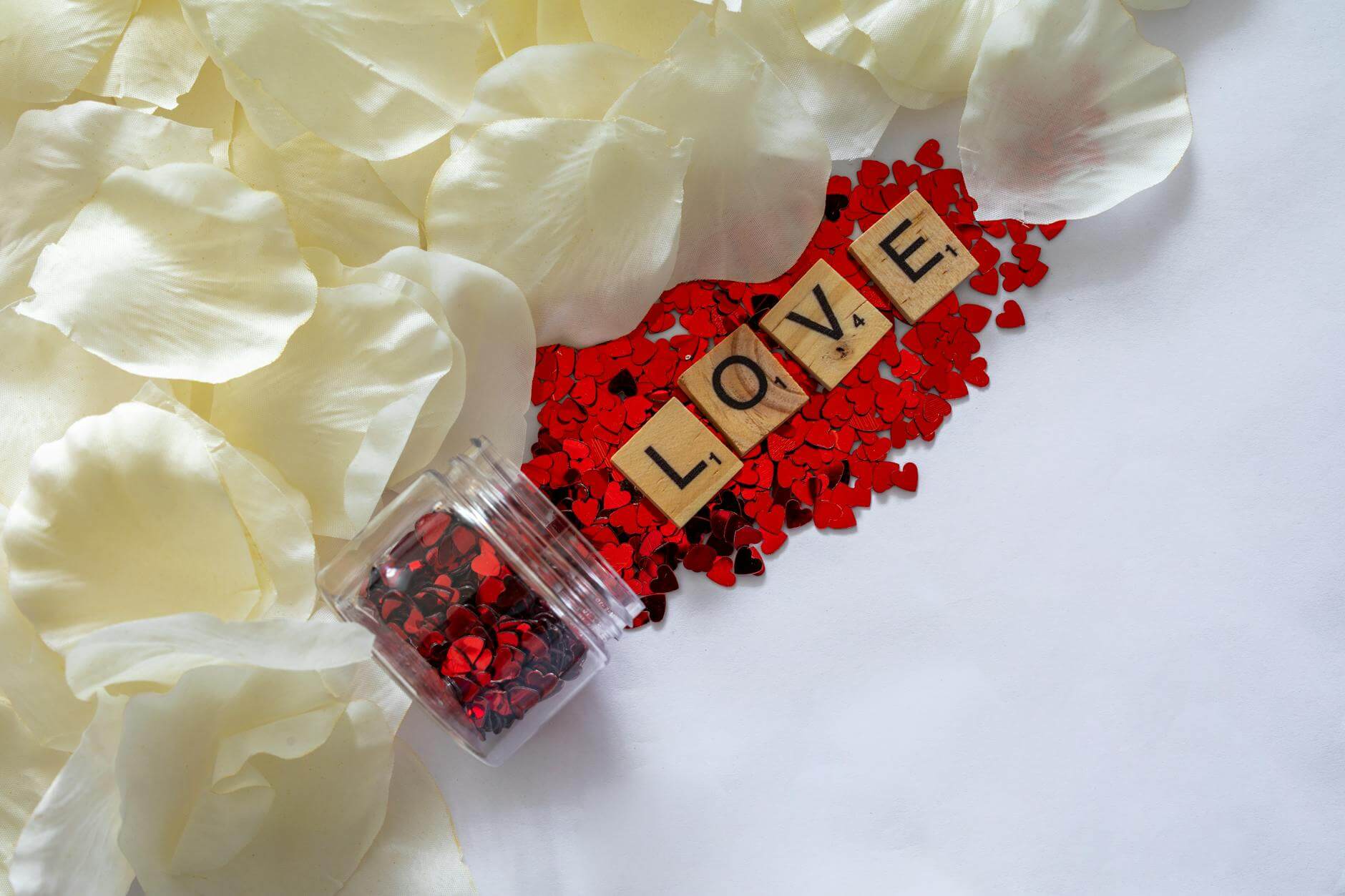 photo of white petals near the word love