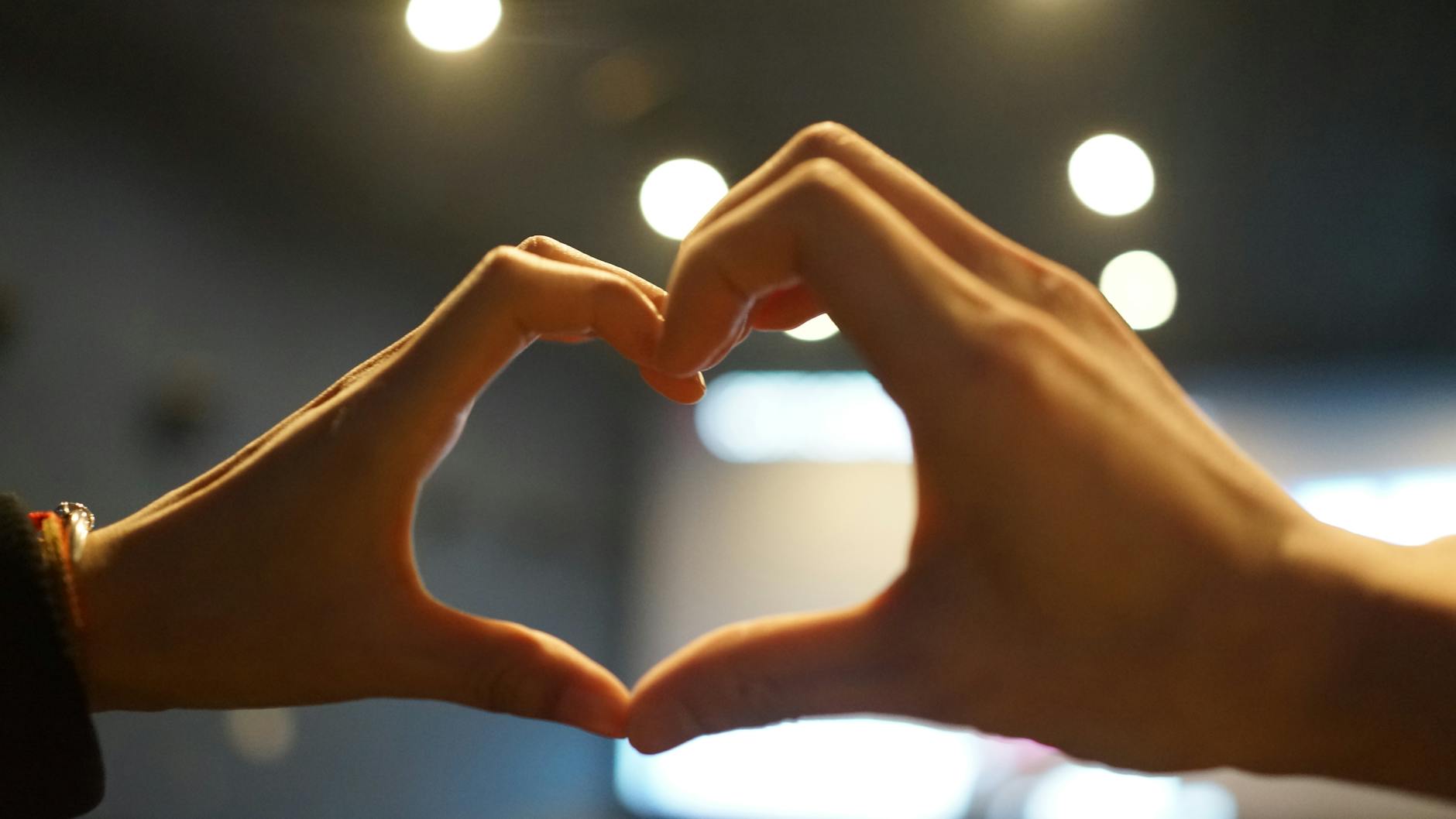 couple hands making heart shape