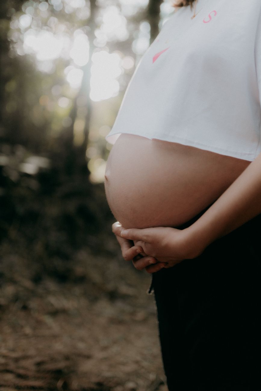pregnant woman embracing nature outdoors