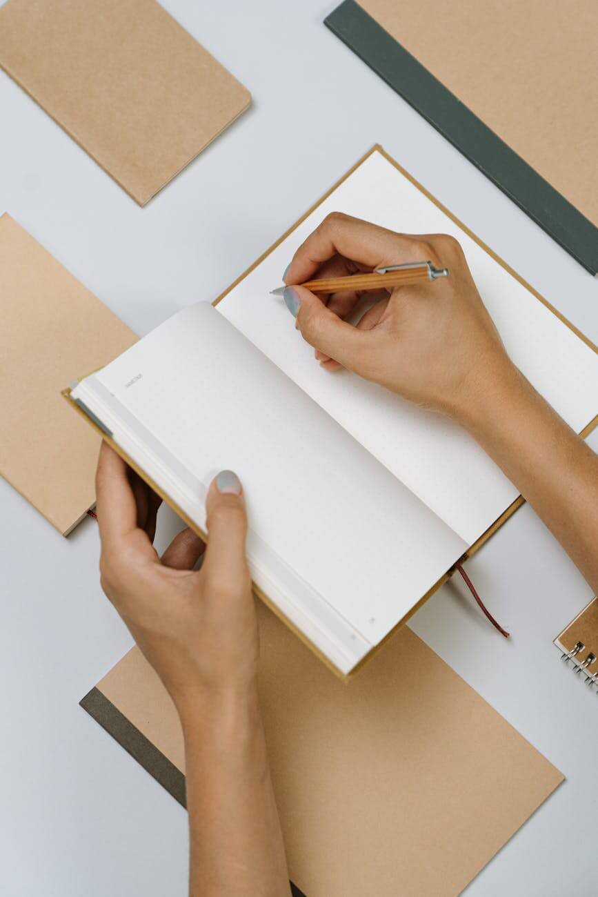 person writing on a planner